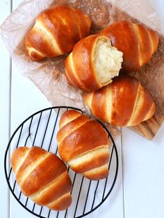 several loaves of bread sitting on top of a wire rack