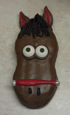 a chocolate horse mask with eyes, nose and mouth painted on it's face