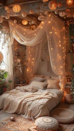 a bedroom decorated in white with fairy lights