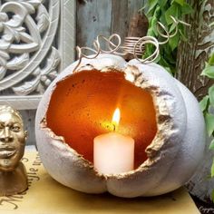 a candle that is inside of a pumpkin