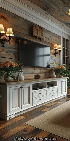 a living room with wood paneled walls and white furniture, including a flat screen tv