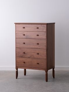 the chest of drawers is made from wood and has five drawers on each side, with three