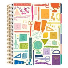 an open notebook with school supplies on the cover and writing utensils around it