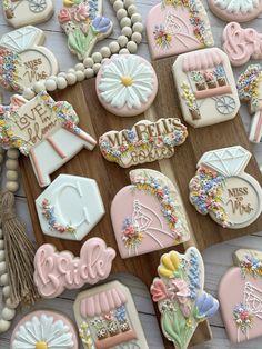 decorated cookies are arranged on a wooden board