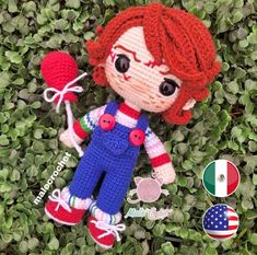 a crocheted doll laying on top of some green grass next to an american flag