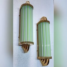 Illuminate your space with a touch of vintage luxury and nautical charm. This stunning pair of Art Deco wall sconces combines the elegance of skyscraper design with the warm glow of opaline green milk glass. Crafted from solid brass and featuring sculptural glass rods, these sconces embody the glamour of the early 20th century, bringing a sophisticated, industrial look to any room. Dimensions: Length: 17 inches Breadth: 4 inches Width: 4 inches Retro Bathroom Mirror And Sconces, Vintage Bathroom Yellow Lights, Upcycling Brass Wall Sconces, 1920s Light Fixtures Shades Of Light, 1940s Bathroom Lights, Art Deco Bedroom Wall Light Fixtures, Art Deco Kitchen Wall Light Fixtures, Art Deco Copper Galight, Bathroom Wall Sconces Single Vanity Art Deco