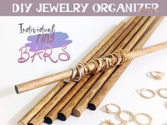 the diy jewelry organizer is made out of wood and has gold rings on it