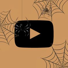 a spider web hanging from the ceiling in front of a screen with an image of a spider on it