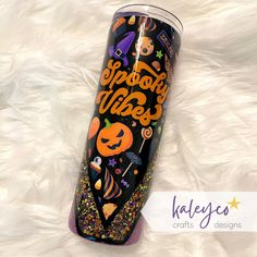 the tumbler cup is decorated with halloween decorations