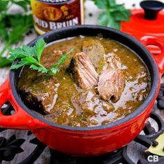 a red pot filled with meat and sauce