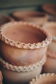 several clay bowls are stacked on top of each other