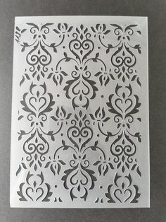 the stencil has been cut out to look like an intricate pattern on a piece of paper