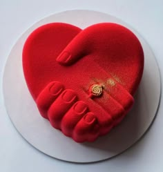 a red heart shaped cake on a white plate