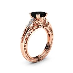 a rose gold engagement ring set with an oval black diamond center stone and two diamonds on the side