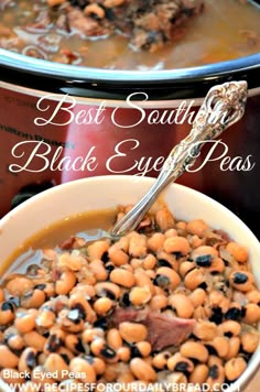 a white bowl filled with beans next to an electric crock pot and a spoon