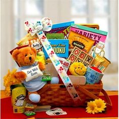 a teddy bear is sitting in a basket filled with snacks and other things to eat