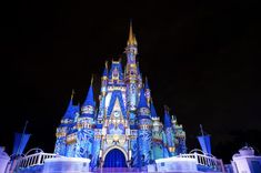 a castle lit up at night with blue lights