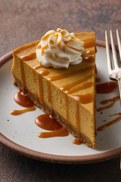 a slice of cheesecake with caramel sauce and whipped cream