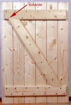 a wooden door with an arrow pointing to the bottom and side paneled in red