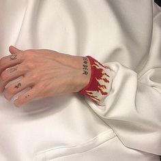 a woman's hand with tattoos on her left wrist and the word love written on it