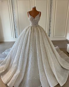 a white wedding dress with sequins on it