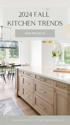 a kitchen with white counter tops and wooden cabinets in front of a window that reads,'2014 fall kitchen trends view projects '