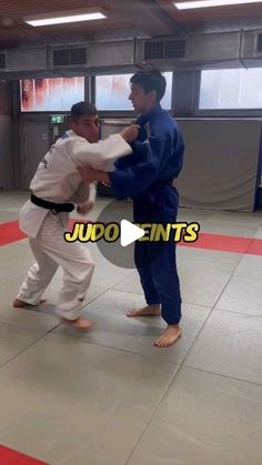 two men are practicing karate in an indoor gym with the words judofints above them