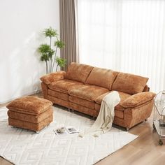 a living room with a brown couch and ottoman