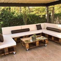 a couch made out of wooden pallets on a patio