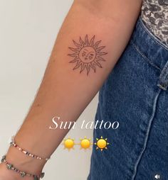 a woman's arm with a sun tattoo on it