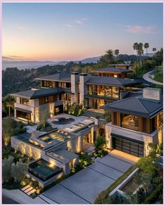 this is an aerial view of the house at dusk, with its lights on and lots of windows