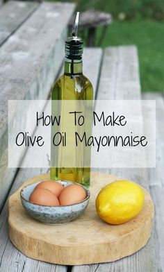 a bottle of olive oil next to an egg and lemon on a cutting board with the words how to make olive oil mayonnaise