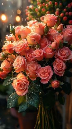 a bouquet of pink roses sitting on top of a table