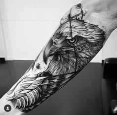 a man's arm with an eagle tattoo on it