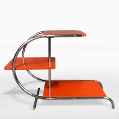 an orange table with two shelves on each side and a metal frame around the edge