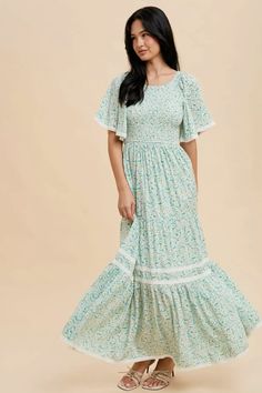 Smocked floral maxi dress with a stretchy smocked bodice, flutter sleeves with pretty lace edges, lace trim detail also on the skirt panel, elastic waistband and tie back detail.

#modesty #modestclothing #modeststyle #modestwear #modestfashionblogger #modestootd 
#womenswear #dressesforwomen #dresses #modestboutique #modest


Self and Lining 100% Rayon

Hand wash in cold water.

Aprox. measurements in inches:

S:Length-53 |Bust-30 |Waist-27

M:Length-54 |Bust-32 |Waist-29

L:Length-54.5 |Bust-34 |Waist-31

modest dresses, modest dress, modest midi, modest maxi, modest fashion, modest trendy dresses, modest boutique, modest attire, modest clothing, modest tops, modest skirts, modest shop