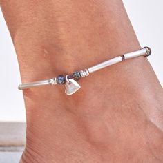 Looking for something to dress up your days of denim and sundresses? Look no further than our Josie Silver & Leather Anklet with Heart Charm. Crafted from a premium blend of silver and leather, this fun anklet is the perfect addition for when you want to give your casual outfits a flirty touch of love. Put it on and make every Summer or Spring outfit a jovial one. The Josie Anklet in silver plate comes adorned with a petite silver heart charm. Feminine and easy going look. single leather strand Leather Anklets, Silver Anklets, Modern Bohemian, Easy Going, Silver Heart, Heart Charm, Spring Outfit, Snug Fit, Anklets