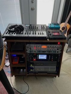 there are many electronic equipment on display in this room, including a keyboard and headphones