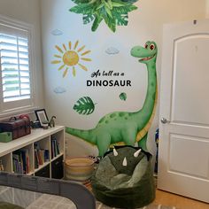 a child's bedroom with a dinosaur themed wall mural