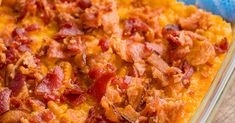 a casserole dish with bacon and cheese on top