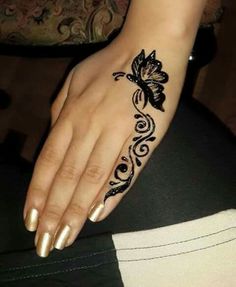 a woman's hand with a tattoo on it