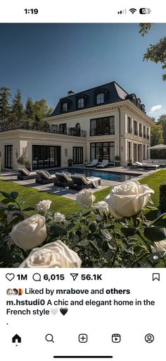 an image of a house with roses in the foreground and on the right side