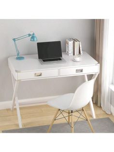 a white desk with a laptop on it