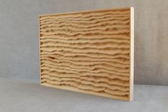 a piece of wood that is made out of plywood and has wavy lines on it