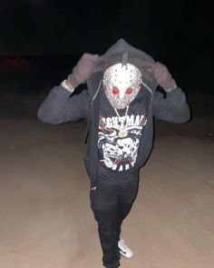 a man in a hoodie with a mask on