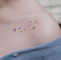 a woman's breast with flowers and butterflies on her left side, which is drawn in pink ink