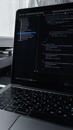 an open laptop computer sitting on top of a desk