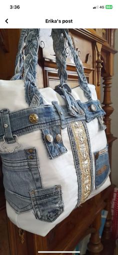 a white purse with gold sequins hanging from it's side on a wooden stand