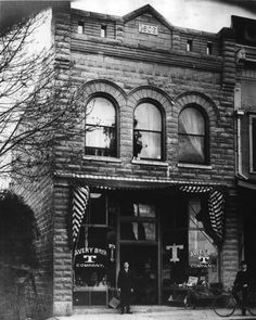 an old black and white photo of a store front