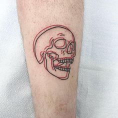 a man with a skull tattoo on his leg